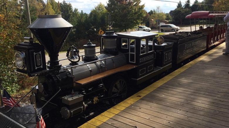 A small train stopped at the platform at Pine Mountain Gold Museum
