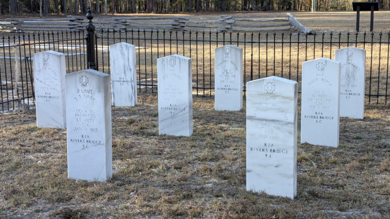 A handful of white headstones in a small gated cemetery at Battle of Rivers Bridge State Historic Site.