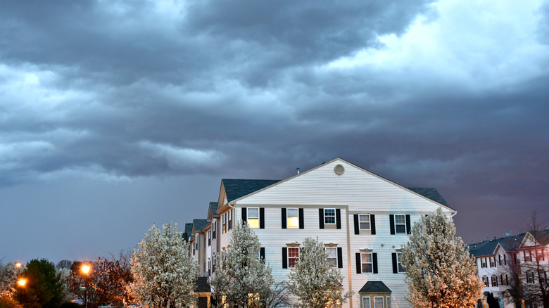 Cloudy night above white homes in town of Odenton, Maryland
