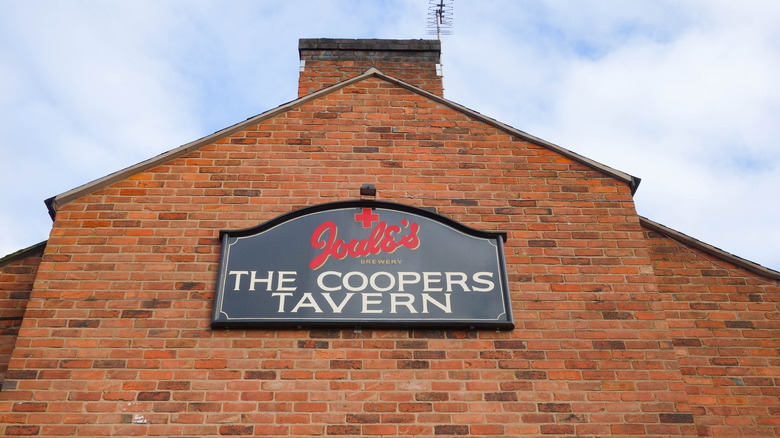 The sign for The Coopers Tavern on a historic brick building in Burton upon Trent