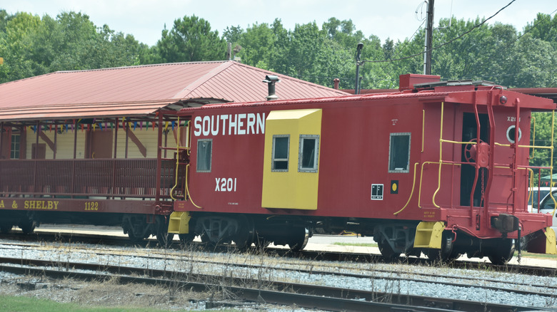 A red train mid-trip