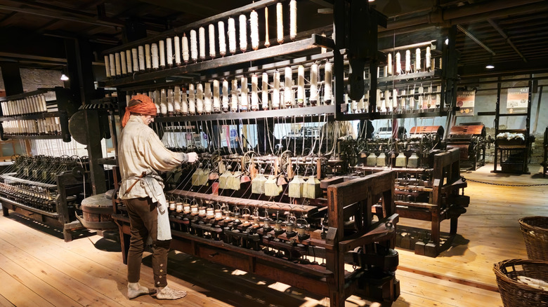 A man working a mill at the Helmshore Mills Textile Museum in Rossendale, England