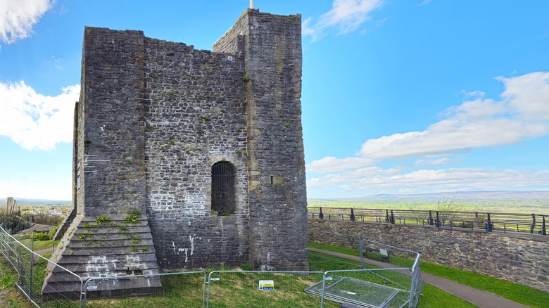 A medieval stone castle keep at Clitheroe Castle on a sunny day