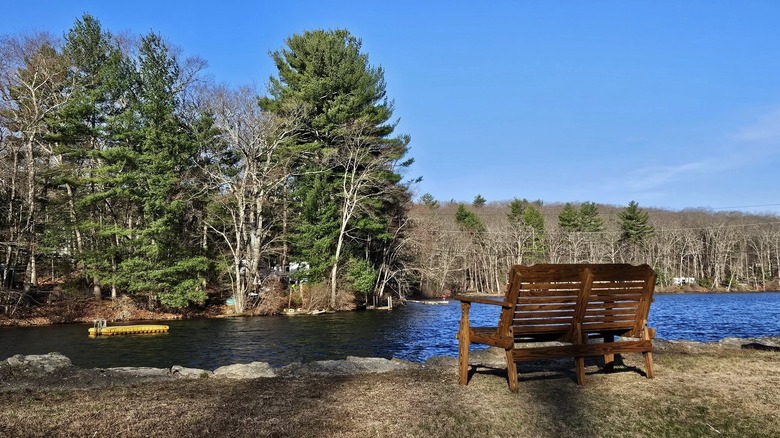A bench stands near Aldrich Mill Pond at Sutton Falls, Massachusetts