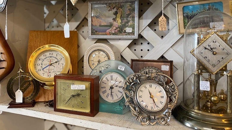 Antique clocks and framed paintings on the shelf at Memory Lane Mall in Downtown Hardy.