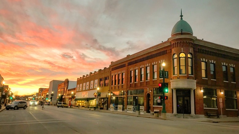 Street view of historic buildings and storefronts at sunset in Monett, Missouri.