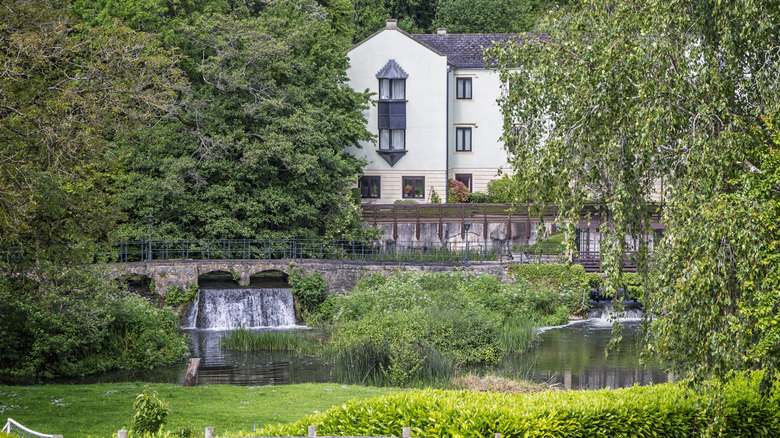 An old mill now used as housing over looks the River Chew in Keynsham