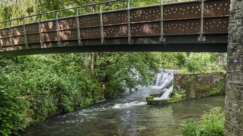 A weir and footbridge over the River Chew in Keynsham UK