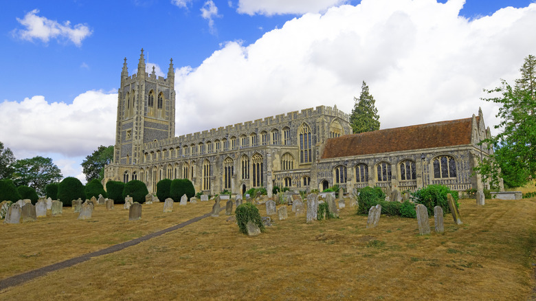 The 15th-century Holy Trinity church surrounded by gravestones in Long Melford, England