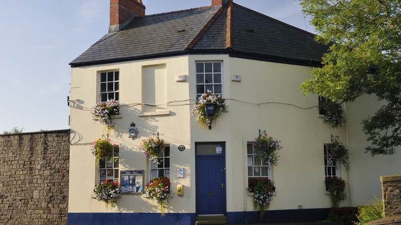 A building covered in blooming flowers on Usk's Bridge Street