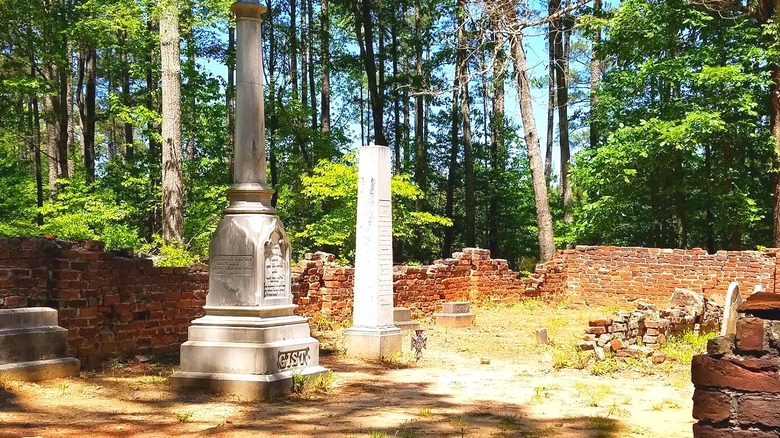 Gist family cemetery on a sunny day surrounded by a low brick wall in disrepair