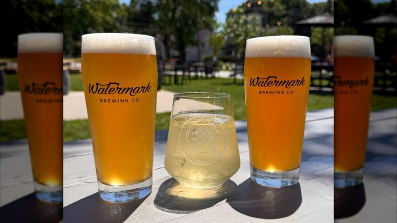 Two glasses of beer and a glass of wine at a brewery