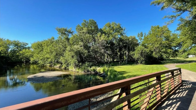A small walking bridge over the Kishwaukee River in David Carroll Memorial Park just off of downtown Genoa