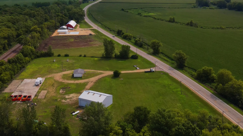Aerial view of SR-72 passing farms and fields on the outskirts of Kirkland, Illinois, in summertime