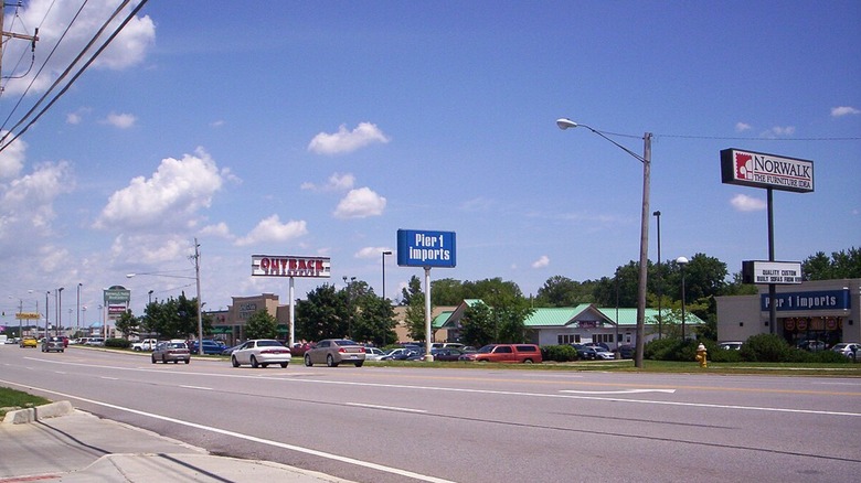 cars and signs along a road in Ontario, Ohio