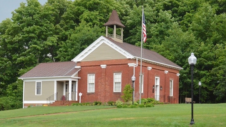 The Little Red Schoolhouse with an Ohio Historical Marker sign in the foreground in Poland, Ohio