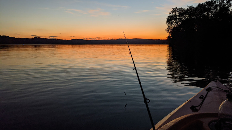 Fishing from a kayak at sunset on Pleasant Hill Lake in Ohio