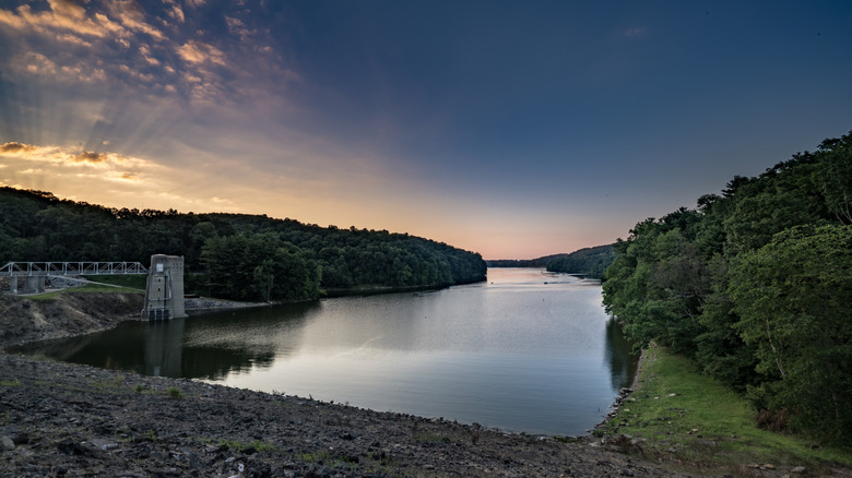 Pleasant Hill Lake and dam in Ohio lined with trees in the evening