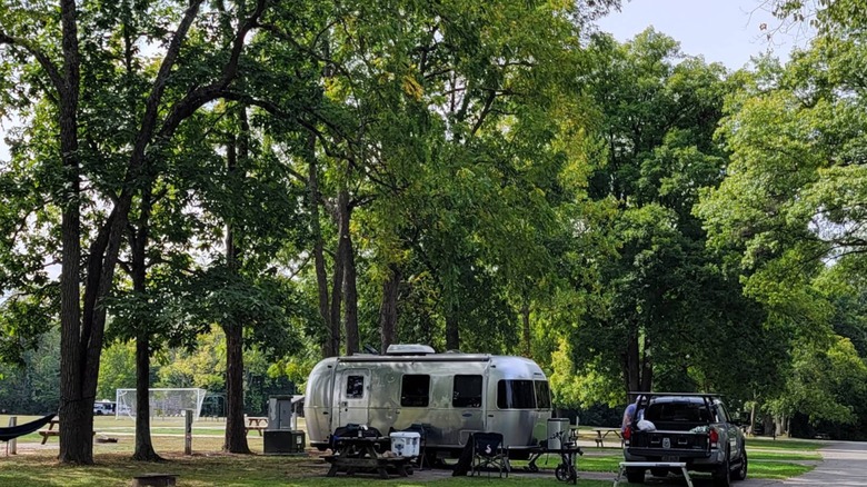An RV trailer and SUV at a campsite at Whitewater Memorial State Park
