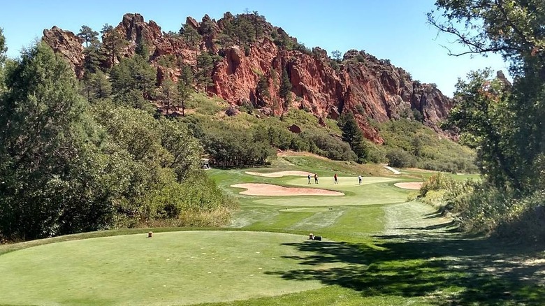 view of red rock formations in distance from Perry Park Country Club golf course