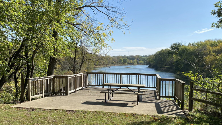 Picnic tables overlooking the river in Frank A. Gotch State Park in Humboldt, Iowa