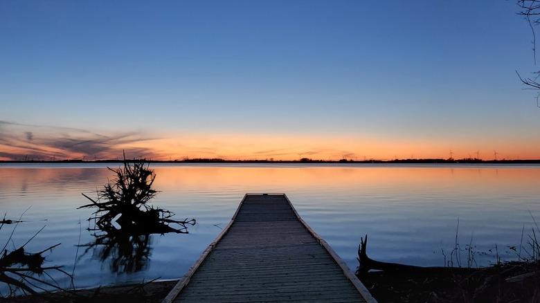 Boat and fishing dock at sunset in Rondeau Park