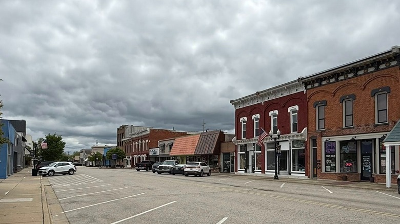 The quiet downtown streets of Imlay City with historic brick buildings lining the street and cloudy skies above