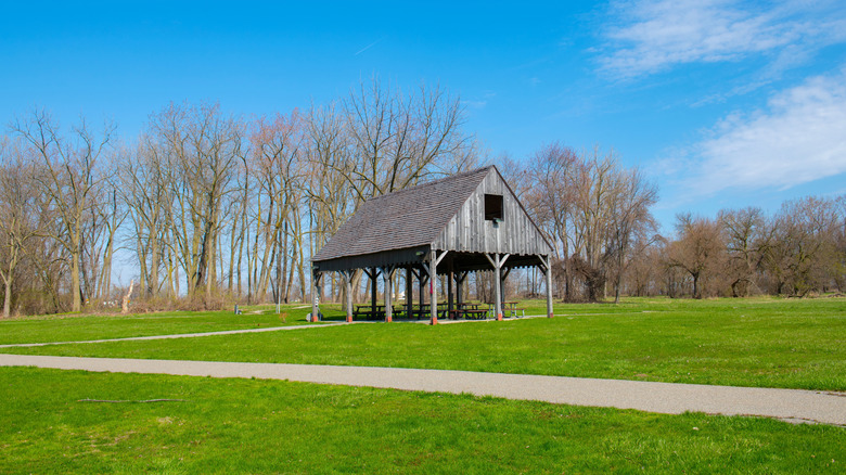 Grassy open areas, trails, and a wooden pavilion on the battlefield at River Raisin Battlefield Park