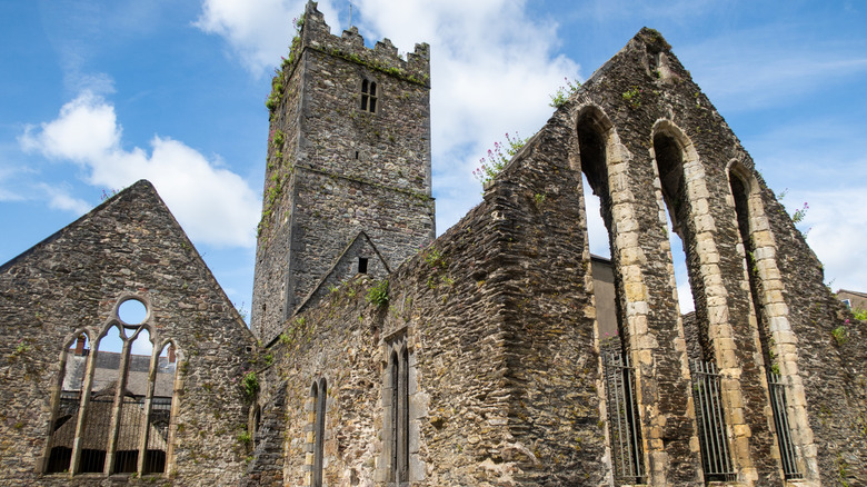 The stone facade of the Greyfriars Abbey in Waterford, Ireland, on a sunny day