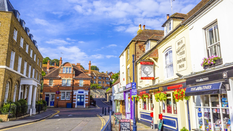 Street view of shops, residences, and an inn in Hythe, England.