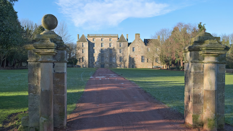 Stone pillars mark the entrance of a long drive through gardens to Kinneil House, a historic mansion in Bo'ness, Scotland