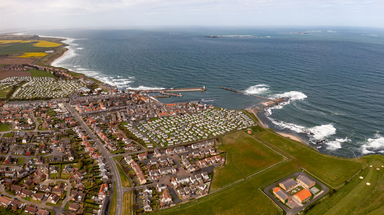 An aerial view of the town and coast of Seahouses, as well as the surrounding landscape and the North Sea