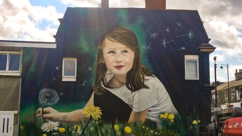 Mural of girl with dandelion on side of building Cowdenbeath