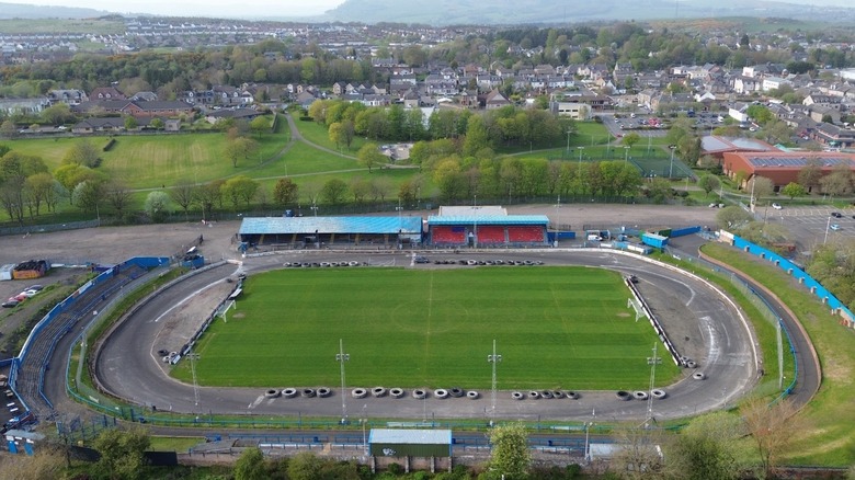 Football field and race track Cowdenbeath seen from above with houses and trees