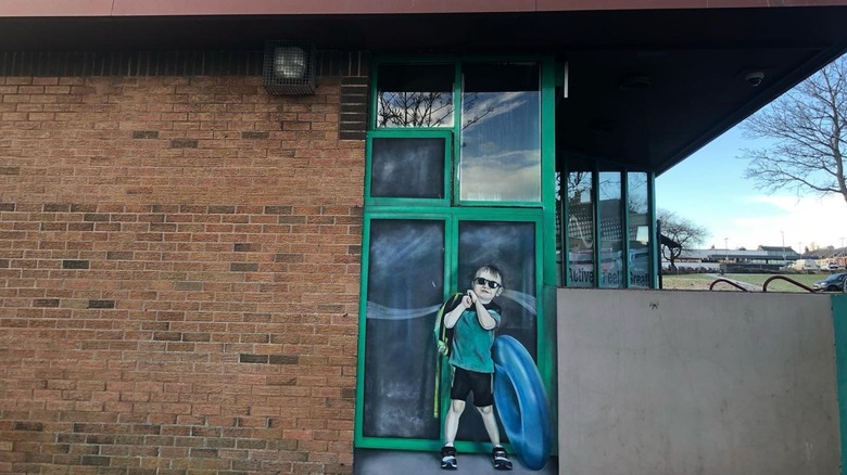 A mural of a boy with a float in Cowdenbeath, Scotland