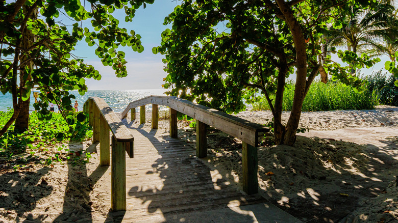 wooden boardwalk leading to Wiggins Pass Beach in Naples, Florida