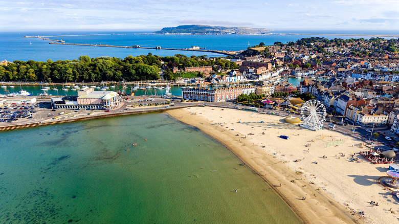 Aerial view of the beachfront, with a Ferris wheel, and budlings in the background in Weymouth, England