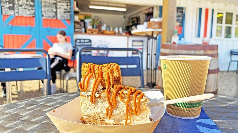 A slice of biscoff cheesecake on a paper plate at Chesil Beach Café