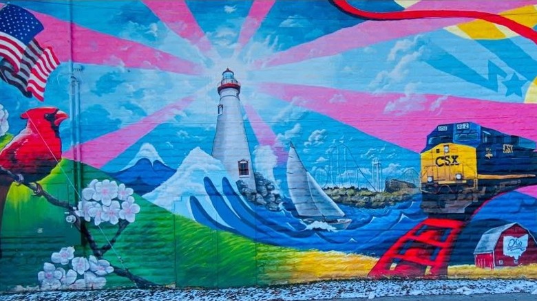 A Fostoria mural featuring Ohio landmarks such as Six Flags with a CSX train in the foreground