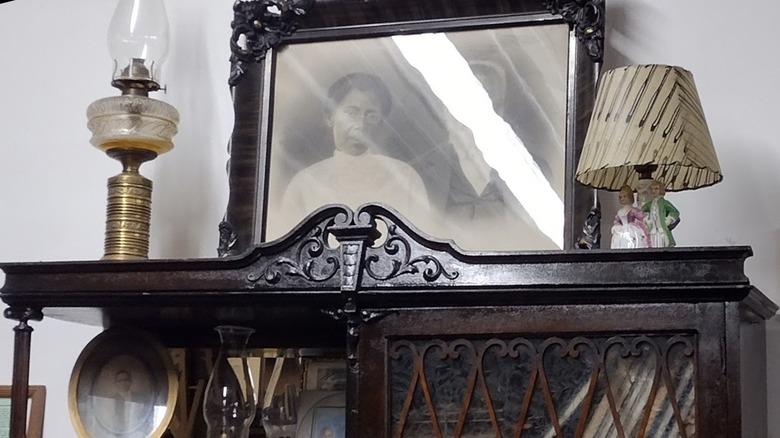 Exhibition details, including a photograph and antique lamps, at Paulding County Historical Museum