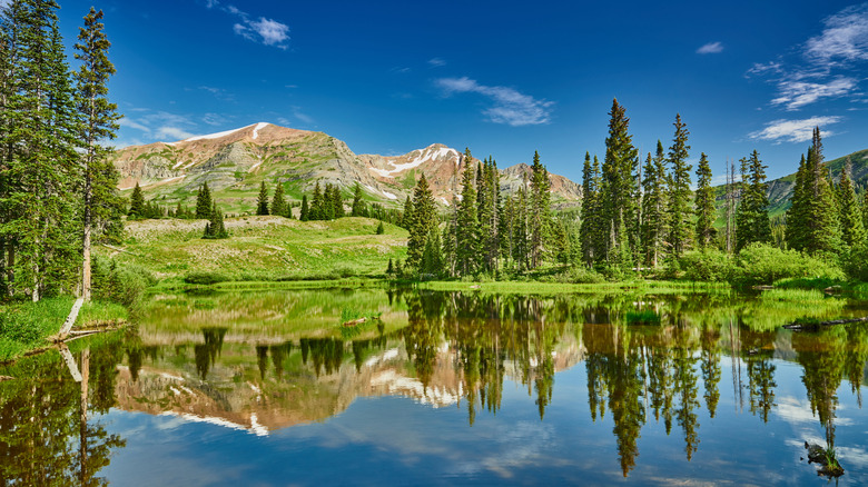 A view across the water and Ruby Peak from the Lake Irwin campground in Colorado
