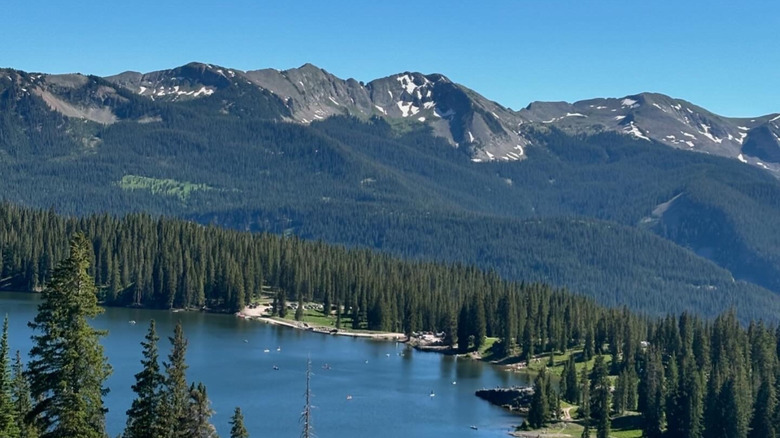 Mountains rise above the forests of Lake Irwin, Colorado