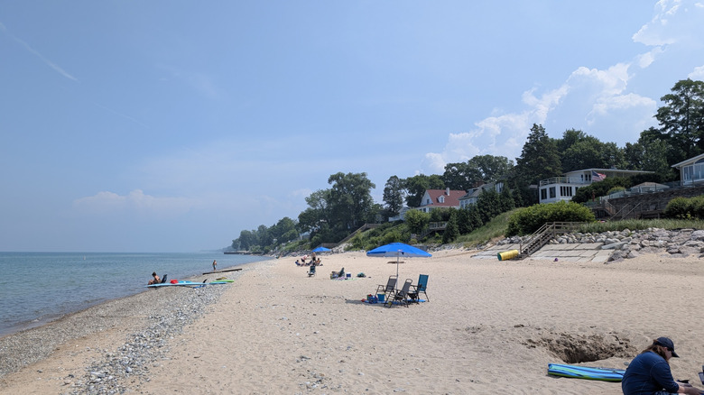 View of people on the beach in Grand Beach, Michigan, with beach houses in the background