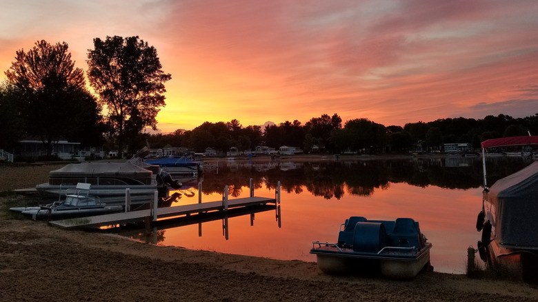Boats and docks along the shore on Monterey Lake at sunset