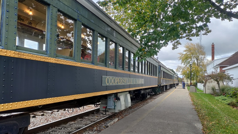 Path next to a carriage of on the Coopersville & Marne Railway train