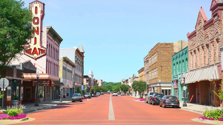 Red street and brick buildings in Ionia, Michigan with the historic Ionia Theater sign on the left hand side