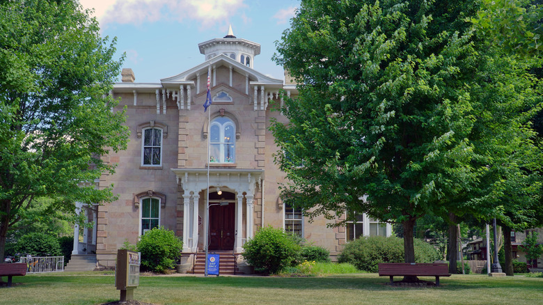 A historic building in Ionia Michigan surrounded by lawns and green trees