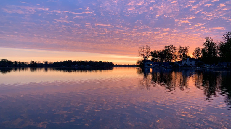 A beautiful sunrise over Morrison Lake creating vibrant blue, yellow, pink, and orange colors reflecting off the water.