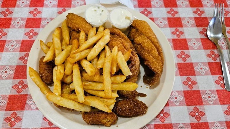 A loaded plate of fried catfish and French fries, served at Gumlog BBQ, a small-town restaurant in Georgia.
