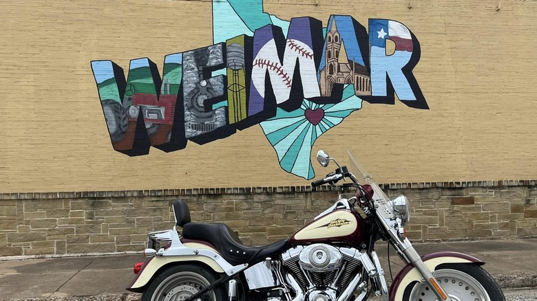 A motorcycle in front of the Weimar mural
